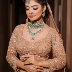 A full-length view of the modern emerald bridal look, showcasing how the makeup complements the entire outfit and jewelry. I emphasize the importance of a cohesive final look in my professional portfolio training.