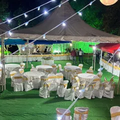 An evening event setup with guest seating and our buffet line visible in the background. We manage the entire catering and seating arrangement to ensure your event runs smoothly from start to finish.