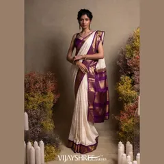 We blend tradition with personal style. This elegant white Kanjivaram silk saree is elevated with a rich purple border and exquisite, custom Chikankari hand embroidery, creating a unique masterpiece for a discerning bride.