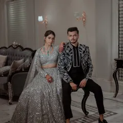 A powerful and stylish portrait of the couple in their coordinated silver and black Sangeet outfits.