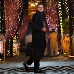 For a modern Sangeet or reception, I created this black open Indo-Western jacket detailed with pipe and katdana work. It's paired with a black koul kurta and tailored trousers for a sharp, contemporary silhouette.