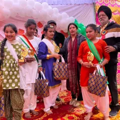 Our students proudly holding their trophies after a Republic Day performance. We train our dancers for competitions and help them achieve their best.