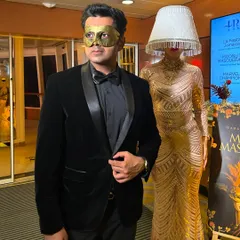 Ready for a moonlight masquerade. The mask adds a layer of mystery, which is the perfect accessory for an evening of illusion and mentalism.