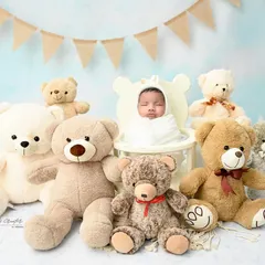 A teddy bear picnic with a very special guest. This little one is surrounded by a crowd of cuddly friends, making for an incredibly cute and heartwarming photo.