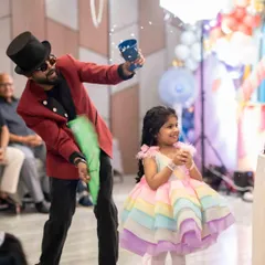 The pure joy of magic. This is a moment of wonder for the birthday princess at her party, as a shower of confetti appears from an empty cup. My goal is to create these happy, magical memories for every child.
