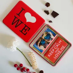 A sweet and personal gift, this tin box includes custom-wrapped chocolates. One chocolate features a personal photo, while the other has a custom message, making it a truly unique treat.
