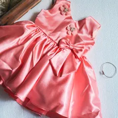 This salmon pink satin dress is all about glamour. I designed it with a full, gathered skirt and delicate floral accents on the shoulder, making it a showstopper for a New Year's party or any grand celebration.