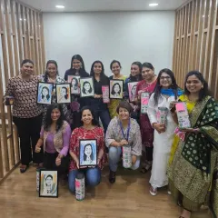 A group photo from the Pidilite Women's Day event, with everyone holding their custom caricatures. It was an honor to be part of their celebration.