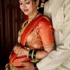 A tender moment from a baby shower photoshoot. The makeup is soft and romantic, with a focus on glowing skin to enhance her maternal radiance.