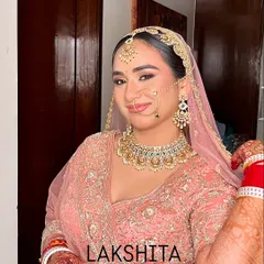 Radiating a bridal glow in a beautiful pink lehenga. This look is all about soft, romantic makeup with shimmering eyes and a matching pink lip tone.
