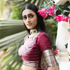 A portrait showcasing our Brick Maroon Mangalagiri silk lehenga. The printed georgette dupatta and custom blouse create a look of regal elegance.
