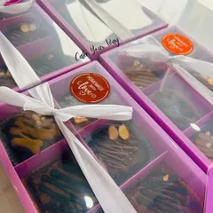 My brownie boxes are perfect for gifting. Here they are, all packed up with a "Homemade with Love" sticker and tied with a white ribbon, ready to be sent out as thoughtful and delicious presents.