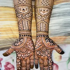 A dense and detailed full-hand design with a mix of traditional Indian patterns, perfect for a classic bridal look.