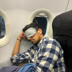 The reality of a destination DJ: catching sleep on a flight between gigs. The hustle is real, but the energy of the crowd makes it all worth it.