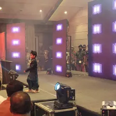 A young performer confidently walking the LED runway at a fashion show event I managed. The lighting and stage effects are programmed to enhance the performance and captivate the audience.