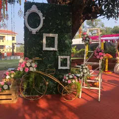 A Haldi ceremony is all about fun and color. We created this vibrant photo corner with a lush green wall, decorative frames, and a flower-adorned vintage bicycle to give guests a beautiful spot for pictures.