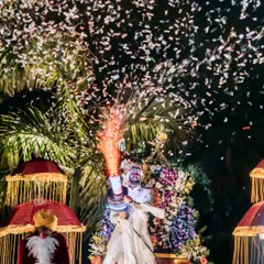 The groom makes a spectacular entrance, shooting confetti into the air. This shot is all about capturing the peak energy and excitement of the Baraat.