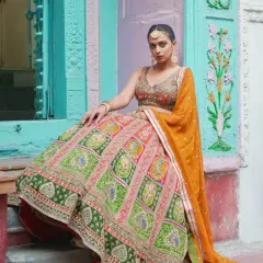 For a look that’s pure heritage with a vibrant twist, this multi-panelled lehenga is it. The rich green and pink panels are detailed with traditional motifs, making it a stunning choice for a sangeet or wedding day.