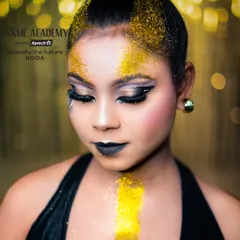 A creative glam look featuring bold black lipstick and gold glitter. Our courses encourage students to experiment with unconventional styles to build a unique and artistic portfolio.
