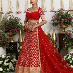 A timeless heirloom, this classic red silk lehenga is a tribute to bridal tradition. The rich golden embroidery and regal Banarasi weave are crafted for a bride's most cherished day, promising a look of unparalleled grace and splendor.