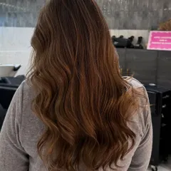 A cool-toned, deep ash blonde that looks stunning and natural on darker hair. The soft, subtle glow is perfect for a sophisticated look.