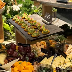 A festive grazing table featuring our popular smashed chili avocado on crostini. The spread is a mix of savory and sweet, with a variety of cheeses, fruits, and dips, perfect for a Christmas party or holiday gathering.