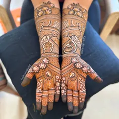 A beautiful full bridal design featuring kalash motifs, yin-yang symbols for balance, and elegant peacocks.