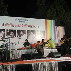 A throwback to a performance at the Pt. Jitendra Abhisheki Mahotsav. This wide shot shows the full band on stage, a lineup of incredible talent creating a fusion of sounds.