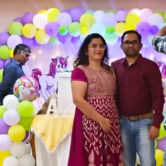 A lovely couple posing in front of the unicorn-themed decoration I created for their daughter's birthday. It's always wonderful to see parents enjoying the celebration.