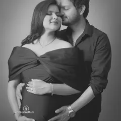 A tender embrace captured in a classic black and white portrait. Removing color allows the focus to fall entirely on the emotion and connection between the couple as they hold the baby bump together.