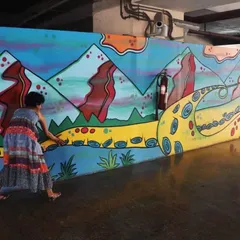 This is the reality of temporary public art. Here I am, painting over a section of my own mural at the metro station, which was later replaced by a commercial advertisement. Though its life was short, it made many commuters smile.