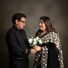 A beautiful portrait of a couple, likely celebrating a milestone anniversary together. This image captures their shared history and affection in a simple, elegant studio setting.