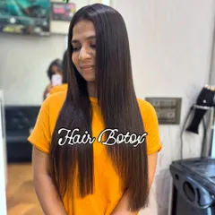 The final result of a Hair Botox treatment. The client's hair is visibly smoother, straighter, and has a healthy shine. This treatment is perfect for anyone struggling with unmanageable, frizzy hair.