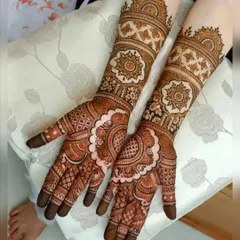 A beautiful, fully covered bridal mehendi with a focus on large mandala patterns on the back of the hands. The arms are adorned with matching geometric and floral bands, creating a cohesive and striking design.
