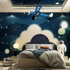 We design kids' rooms that spark imagination and grow with your child. This space-themed bedroom features a galaxy mural on the ceiling and walls, a custom airplane light fixture, and an astronaut figure, turning a simple room into a universe of adventure.