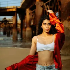 A beach shoot doesn't have to be just sand and water. I love finding these industrial elements, like this old rusted pier, to create a strong contrast and a more editorial, high-fashion feel against the soft beach backdrop.