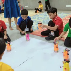 It's robot race day! After building their own scribbling bots from scratch, students get to see their creations come to life, drawing unique patterns as they zoom around.
