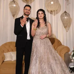 The happy couple showing off their rings. Her makeup is soft and pretty, perfect for the occasion.