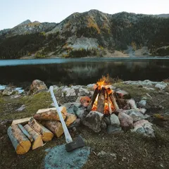 A classic lakeside campfire scene. I prepare the firewood and the fire pit, so all you need to do is settle in and enjoy the warmth against the cool air coming off the water. The mountain view across the lake makes it even more special.