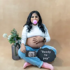 "Ready to pop!" We love having fun during our sessions. This casual studio shot with jeans and a playful prop is a perfect example.