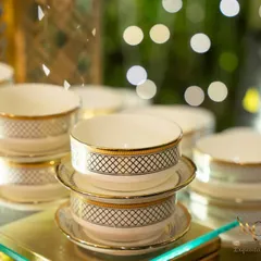 A stack of our elegant, gold-rimmed soup bowls. We believe that fine crockery enhances the dining experience, and we select each piece to complement the menu and the event's decor.