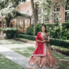 A beautiful solo portrait of the bride, showcasing her intricate and colorful lehenga. Her happy smile completes this perfect shot.