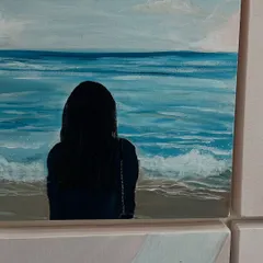 A serene moment by the sea, painted on a small canvas. This piece adds a sense of calm and introspection to the gallery wall collection.