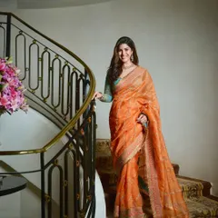 Another shot of Nimrat's elegant look on a grand staircase. The soft waves in her hair and the glowing makeup come together to create a look of pure grace for this special occasion.