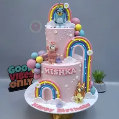This Bluey-themed two-tier cake was a dream to make. The pastel colors, rainbows, and handcrafted characters like Bluey and Bingo make it a truly special creation.