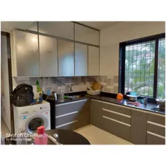Another view of the same kitchen, showing the frosted glass profile shutters on the upper cabinets. This adds a modern touch and helps break the monotony of solid cabinet fronts.