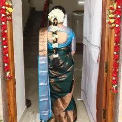 This is a classic South Indian hairstyle featuring a traditional braid, beautifully decorated with fresh jasmine flowers, or 'malli poo'. It's an elegant choice that perfectly complements a silk saree for any wedding or festive function.