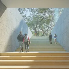 A grand staircase at the Qutub-Shahi Centre, designed to lead visitors up towards the park. The angled walls frame the view of the trees, creating a powerful sense of arrival and connection to nature.