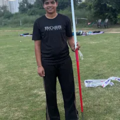 A female athlete poses with her javelin. Confidence is a key part of performance, and we build it through rigorous preparation.