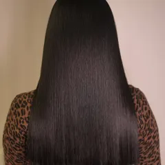After: The stunning result of our Cysteine smoothing treatment. The hair is incredibly smooth, sleek, and shiny, completely transforming the texture.